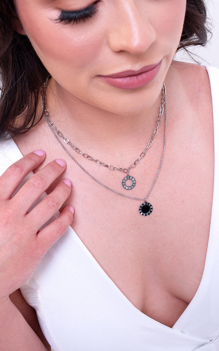 Elegant two-layer silver necklace by Clarizzma, featuring a delicate chain and stylish black and silver pendants. Perfect for casual or chic outfits.